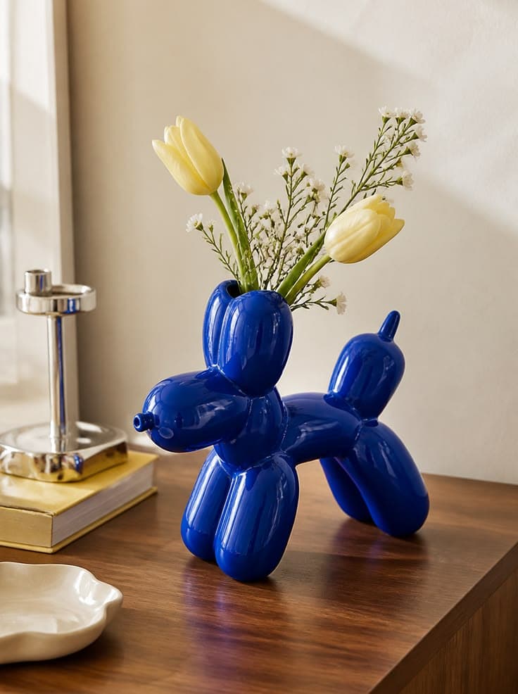 Vase bleu en forme de chien ballon avec fleurs jaunes